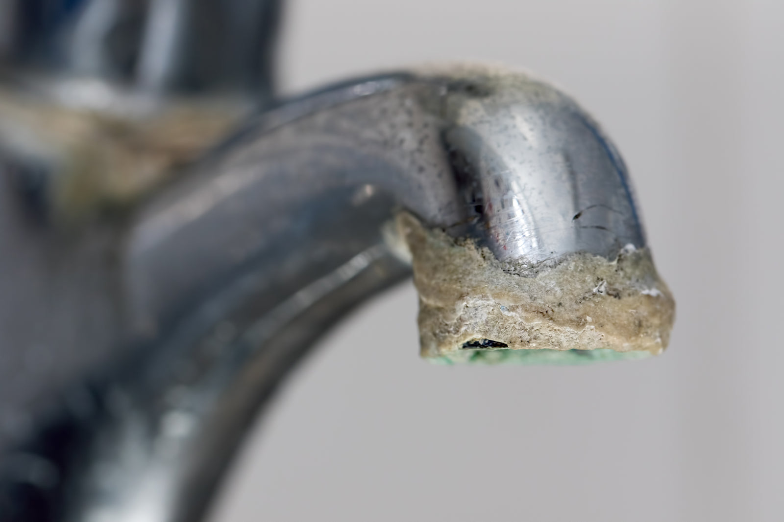Scale build-up on water faucet cause by calcium in water