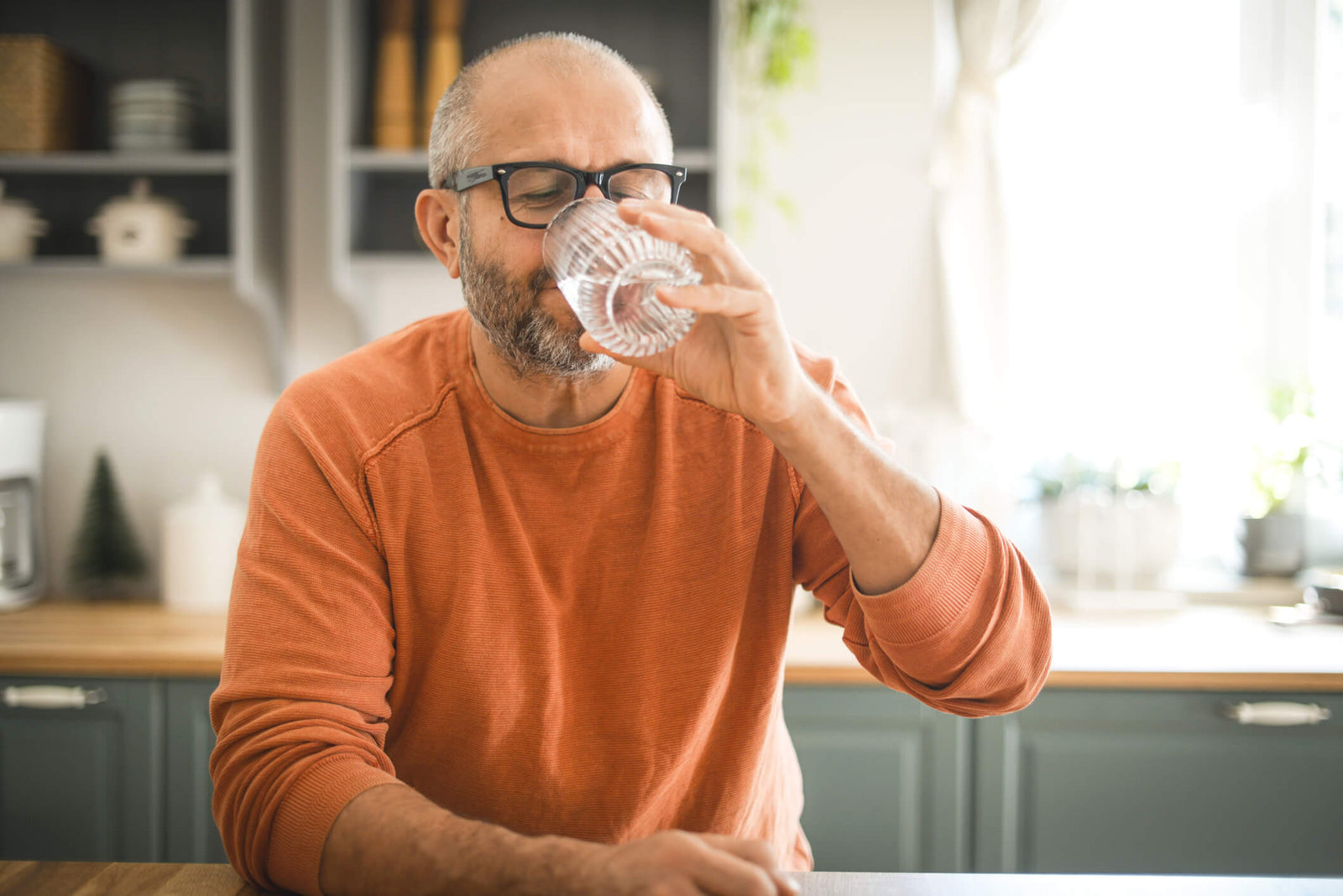 man drinking glass of water